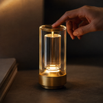 Lampe Fanal dorée : main tenant le dessus, lanterne en verre avec lumière