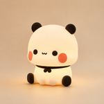 Veilleuse panda en forme de petit panda blanc, yeux noirs et oreilles rondes.