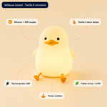 Veilleuse canard jaune pâle, forme ronde lumineuse avec pattes et bec orange.