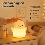 Veilleuse manchot allumée, contact tactile sur le dessus, lumière blanche, bec jaune.