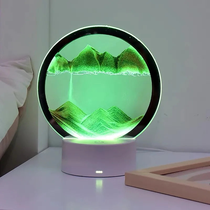 Lampe sablier cinétique LED ronde, relief vert sur socle blanc avec lumière LED.