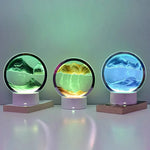 Lampe sablier cinétique LED à disques ronds, reliefs vert, jaune et bleu sur socle.