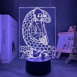 Veilleuse LED 3D manga sur socle noir, personnage assis avec lumière bleue vive.