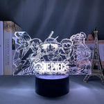 Lampe LED 3D motif «ONE PIECE» en lignes bleues, socle noir cylindrique.